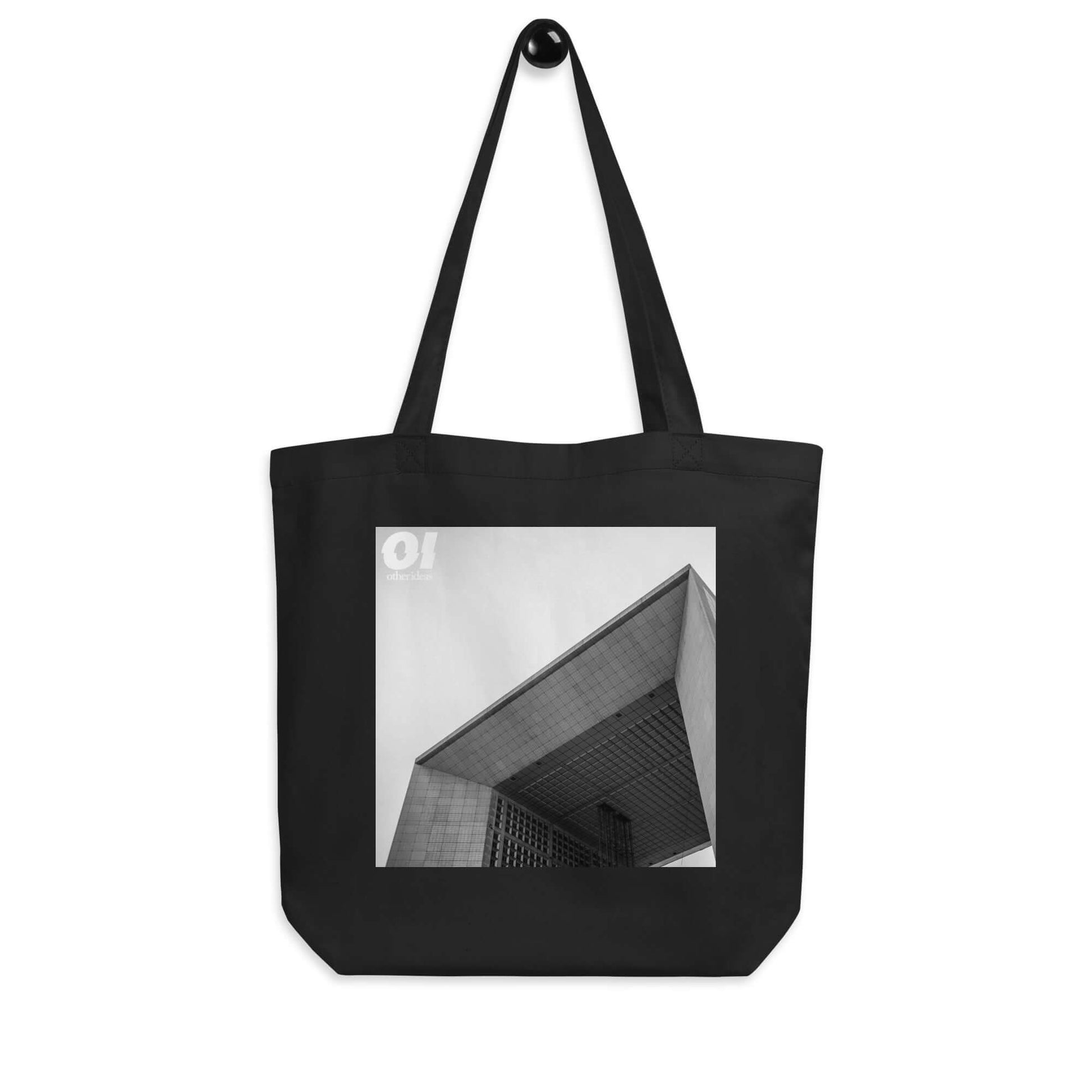 other ideas eco streetwear black organic cotton canvas streetstyle tote bag with black and white Paris La Defense printed on hanger view