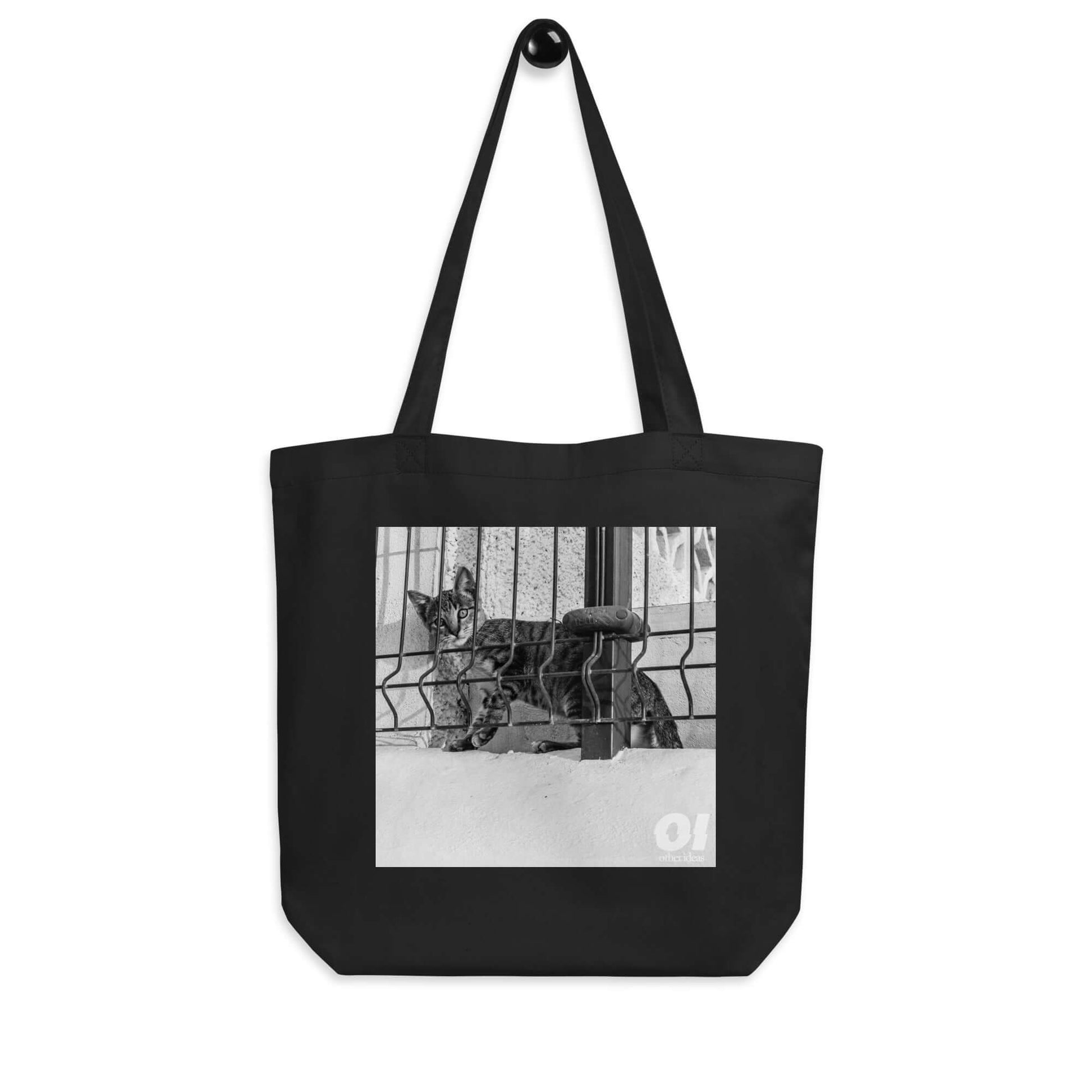 other ideas eco streetwear black organic cotton canvas streetstyle tote bag with black and white nosy cat printed on hanger view