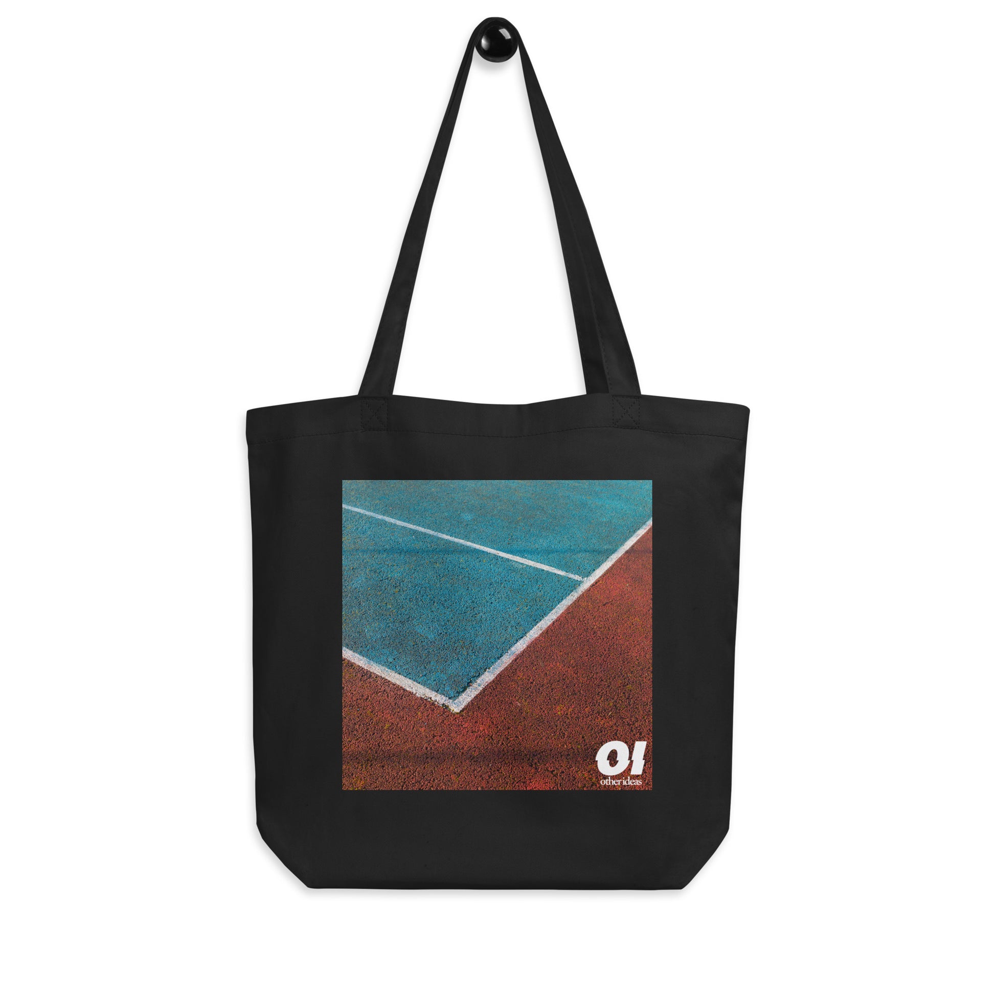 other ideas eco streetwear black organic cotton canvas streetstyle tote bag with high contrast colour tennis court photo printed on hanger view