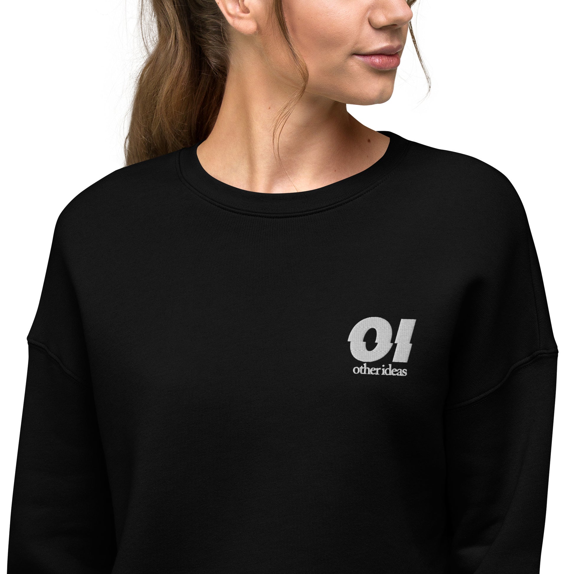 other ideas eco streetwear sustainable women's black cropped sweatshirt logo embroidered slow fashion modelled front view zoomed in showing logo detail