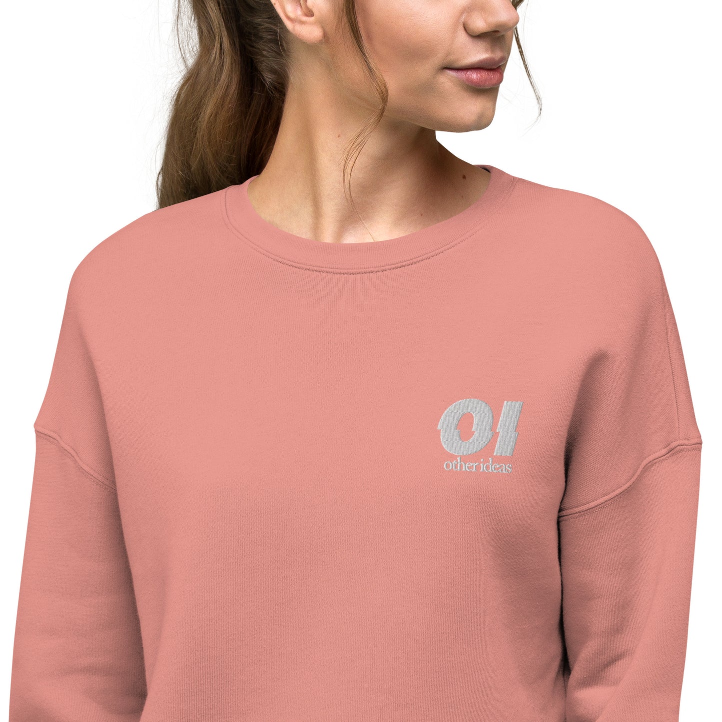 other ideas eco streetwear sustainable women's canyon pink cropped sweatshirt logo embroidered slow fashion modelled zoomed in front view showing logo detail